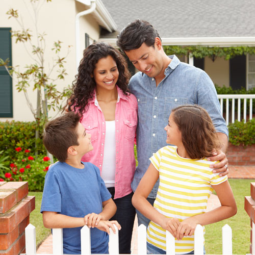 Family standing outside of their home.